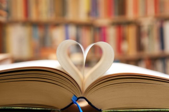 Book,Page,In,Heart,Shape,With,Library,Background